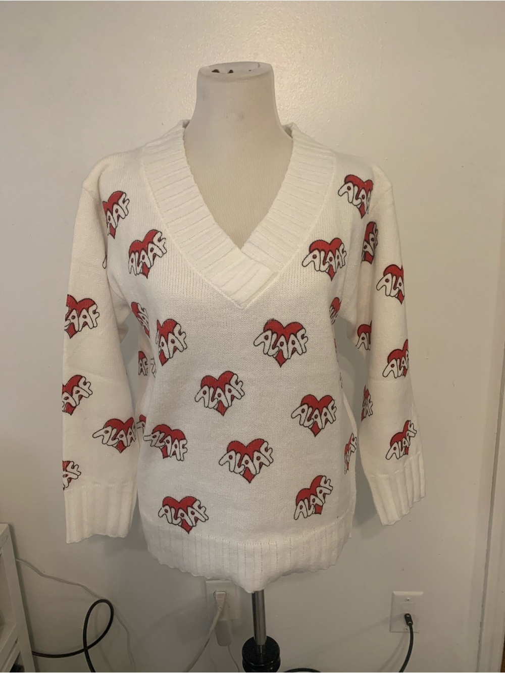 White V-Neck Sweater with Red Heart Logo Pattern